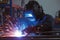 Manufacturing precision Close up of a welder starting work in an industrial setting