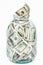 Many 100 US dollars bank notes in a glass jar