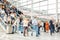 Many anonymous people on escalator of a trade fair