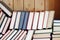 Many assorted old books casually lays in heap front view closeup