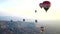 Many balloons flying over the valleys in Goreme, Turkey.