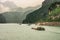 Many barges sailing upriver Yangtze River West of 3 Gorges Dam, Zigui, China