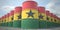 Many barrels with flag of Ghana. Oil or chemical industry supply related 3D rendering