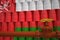 Many barrels with flag of Oman and oil pipe. 3d rendering