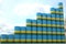 Many barrels with flag of Rwanda form rising chart or upwards trend. National oil industry success concept. 3D rendering