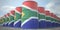 Many barrels with flag of South Africa. Oil or chemical industry supply related 3D rendering