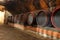 Many barrels of wine stored on shelf in cellar