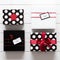 Many beautifully wrapped black, red and white christmas presents