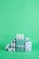 Many beautifully wrapped gift boxes on green background. Space for text