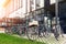 Many bike parked near modern apartment residential buiding or college campus at downtown of european city street. Eco-friendly