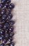 Many bilberry fruits, on gray linen table cloth