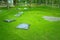 Many black pillow setting on green grass at outdoor garden for resting.