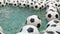 Many Black and White Soccer Balls Background. Football Balls Swimming in a Pure Water. Jets of Water Fall From Above