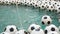 Many Black and White Soccer Balls Background. Football Balls Swimming in a Pure Water. One Ball Falls Into the Water