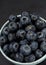 Many blueberries background in a plate on a black background Stacked image Still life photography