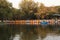 Many boat on the lake in autumn forest.