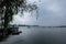 many boats are in the water under a cloudy sky that is covering the bridge