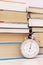 Many books on bookshelf and retro stopwatch. Concept speed reading, back to scholl