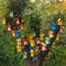 Many bright colored birdhouses on a tree.