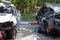 Many broken cars after a traffic accident in the parking lot of a restoration service station on the street. Car body damage