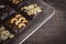 Many Brownie cake with almond slices placed in the basket on wood table