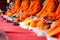 Many Buddha monk sit on the red carpet prepare to pray and doing buddhist ceremony.