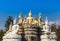 Many buddha statue sitting on blue sky background