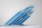 Many or bunch of blue pencils on abstract white background. Education, student, leadership and stationery concept.