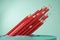 Many or bunch of red pencils on abstract backdrop. Education, student, leadership and stationery concept. 3D Rendering