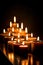 Many burning candles with shallow depth of field. AI generated
