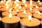 Many burning candles on table, closeup. Symbol of
