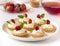 Many cakes or mini tart with fresh fruits, whipped cream and mints