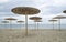 Many cane umbrellas on the beach in cloudy day