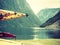 Many canoes on norwegian fjord shore