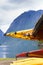 Many canoes on norwegian fjord shore