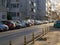 Many cars parked on the roadside in the sleeping area of a city in the evening. Cityscape in the winter evening