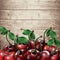 Many cherries on wooden texture background.