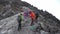 Many climbers hike towards the summit of Mount Meru in Arusha National Park in Tanzania