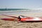 Many color windsurfing lying on the beach. Sea sport activity.