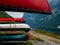 Many colored canoes stored at a renting place at a swiss mountain lake