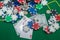 many colored chips of cards and dollars are scattered for poker.