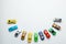 Many colored little toy cars on a gray background