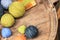 Many colored yarns roll into spheres. Placed on a wooden table