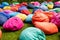 Many colorful beanbags seats at grass outdoors