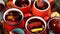 Many colorful cups with mulled wine on festive table