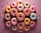 many colorful donuts arranged in a circle on a pink background
