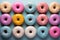 many colorful donuts arranged in a row on a blue background