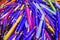 Many colorful, glossy ballpoint pens