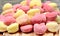 Many colorful gnocchi hearts on a cutting board