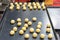 Many colorful loaf dough raw material of chinese pastry before baked in oven on tray in shelves of industrial food